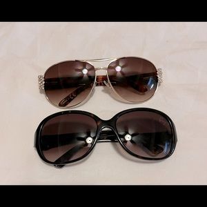 Two pair of Betsey Johnson sunglasses.